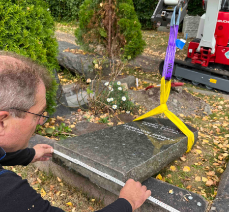 Ensuring a secure and respectful memorial setup. The serene cemetery setting highlights the importance of professional methods in preserving the dignity of the site.